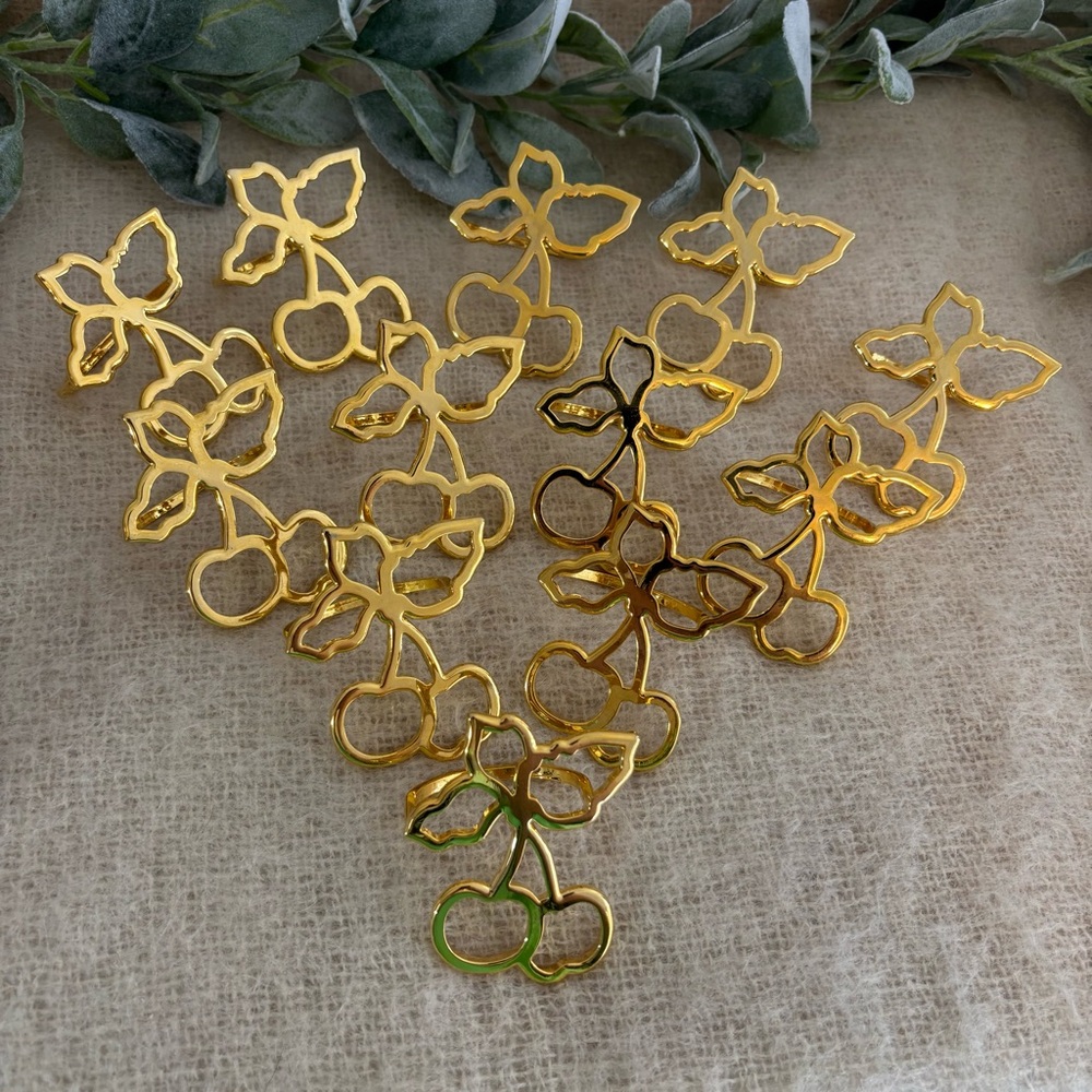 Set of 12 gold tone napkin rings shaped like cherries